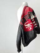 Black leather jacket with red and white logos on a mannequin against a gray background