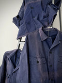 Blue denim jacket on a ladder against a white background